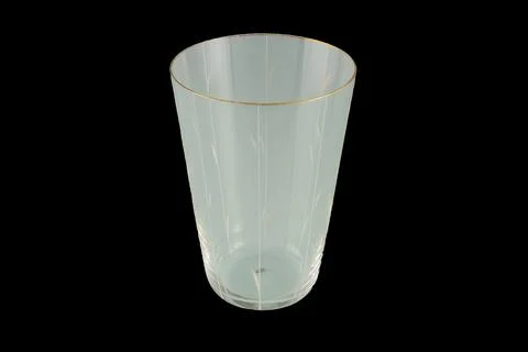 Empty Transparent Drinking Glass With Gold Rim And Etched Vertical Pattern .. Stock Photos