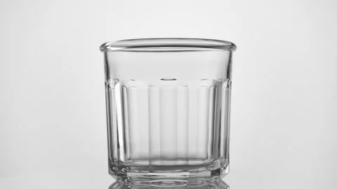 Empty transparent drinking glass rotate on white background. Stock Footage 170619183