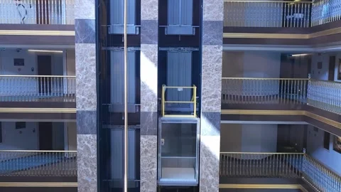 An empty transparent elevator gracefully ascends, showcasing modern design and Vidéo 277182466