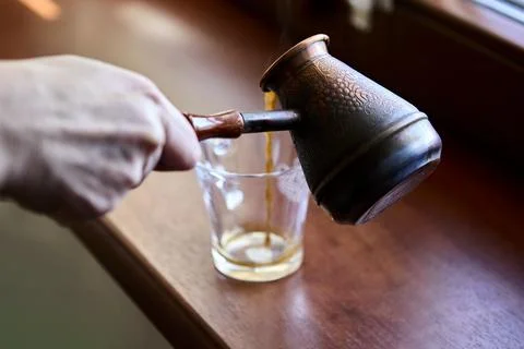 Empty transparent glass after coffee drinking on windowsill Stock Photos