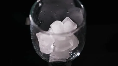 Empty Transparent Glass on Dark Background with Dramatic Lighting Stock Footage 339366119