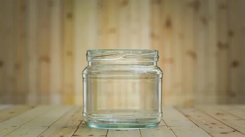 Empty transparent glass jar for canning on wooden table. Glass jar for food on Stock Illustration