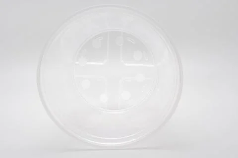Empty transparent plastic cup lying on side isolated on white Stock Photos