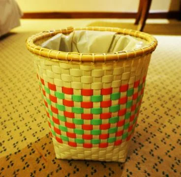Empty trash bin on floor of bedroom Stock Photos