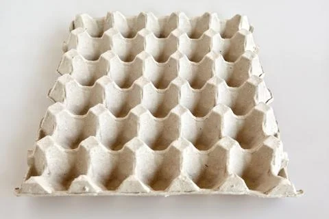Empty tray (bucket) of eggs on the white table 스톡 사진
