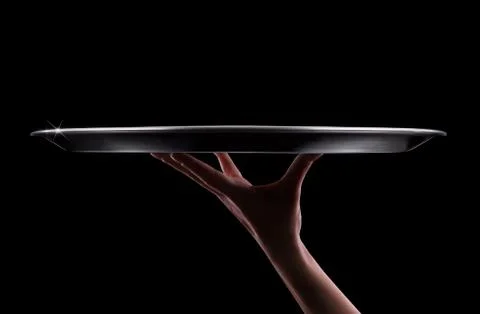 Empty tray in hand waiter on black Stock Photos