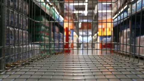 Empty trolley moving through supermarket aisle Stock Footage 98100497