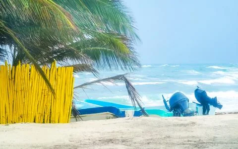 Empty tropical beach with palm trees and boats in windy Cozumel Mexico. Stock Photos