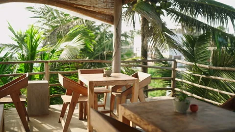 Empty tropical rooftop cafe by the sea at resort waiting for guests and clients Stock Footage 240814749