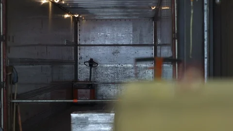 Empty truck to miniature model workman on life-size pallet in real ware house. Stock Footage 102554915