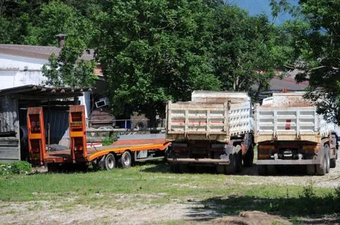 Empty trucks on a construction site in the mountains Stock Photos