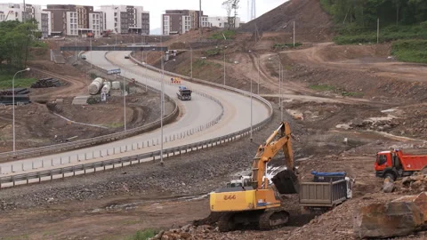 Empty trucks drive up to the excavator for a ground, which it must remove from t Stock Footage 92200154