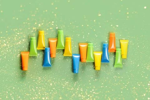Empty tubes for the design of cosmetics on green background. Stock Photos