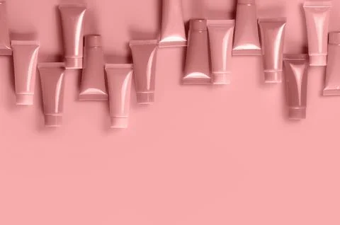 Empty tubes for the design of cosmetics on red background. Stock Photos