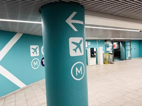 Empty turquoise metro station interior with airport signage and directional.. Stock Photos