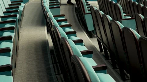 Empty turquoise theater chair awaiting audience 库存影片 340897451