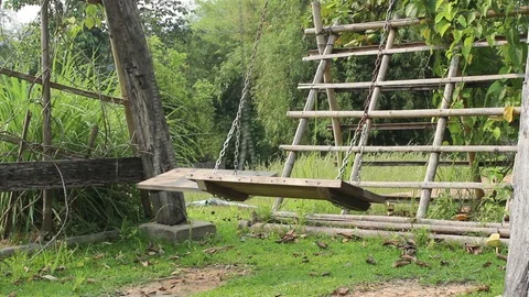 Empty two swings swaying in garden Stock Footage 88760322