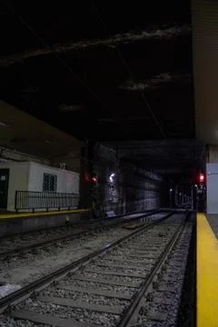 Empty underground train tunnel. Dark subway station. Stock Photos