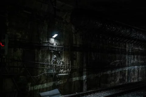Empty underground train tunnel. Dark close-up subway station. Stock Photos