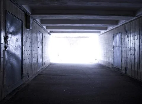 Empty Underground Tunnel with Bright Exit Light Stock Photos