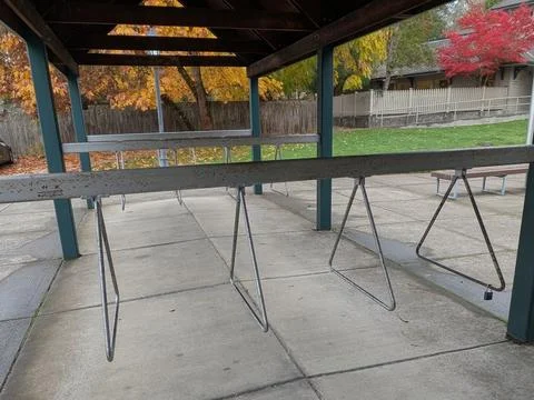 An empty, uniquely designed bike rack made of metal poles and triangular holders Stock Photos
