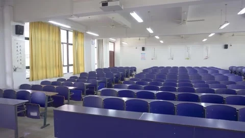 Empty University Lecture Hall With Rows Of Blue Chairs And Soft Indoor Lighting Stock Footage 342208418