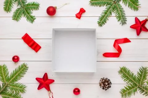 Empty, unpacked gift box surrounded with Christmas decorations, and piece of  Stock Photos