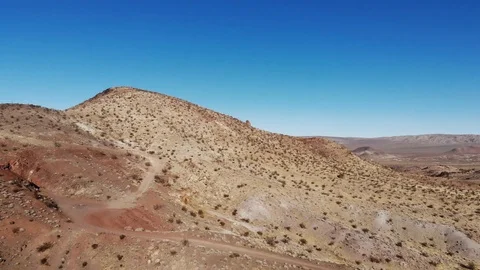 Empty Unpaved dirt road in desert mountain Stock Footage 88062410