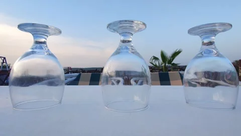 Empty Upside Down Glasses On White Table Stock Footage 343574537
