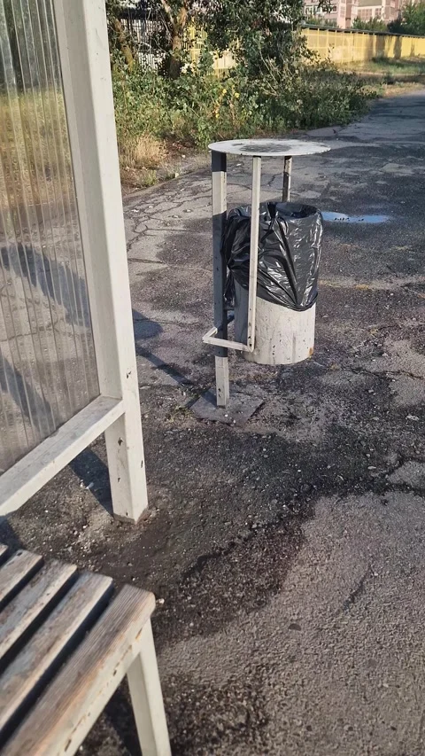 Empty Urban Bus Stop with Trash Can Stock Footage 318345235