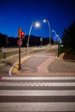Empty Urban Intersection with Modern Street Lamps at Night Stock Photos