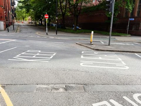 Empty urban street intersection with keep clear road markings in Manchester.. Stock Photos