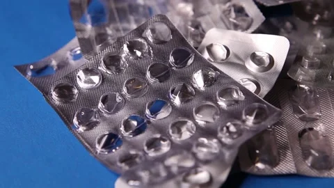 Empty used blister package and pill on blue background Stock Footage 142320917