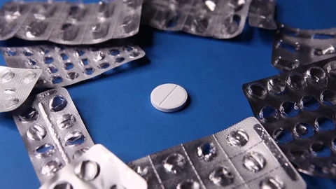 Empty used blister package and pill on blue background Stock Footage 142526113