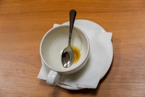 Empty used coffee Cup with spoon inside 写真素材
