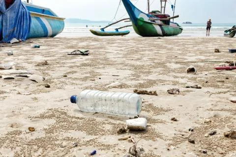 Empty used plastic bottle and other waste thrown out at sea beach. Stock Photos