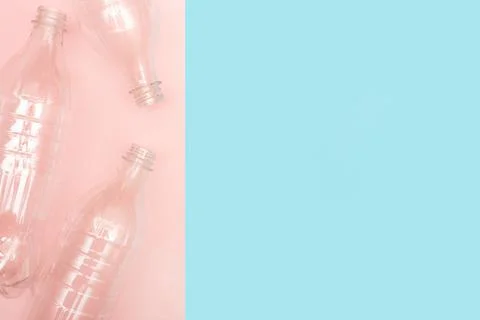Empty used plastic bottles on blue and pink background with place for text. Copy Stock Photos