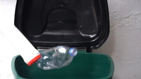 Empty used plastic bottles falls into the trash can slow motion Stock Footage 121143687