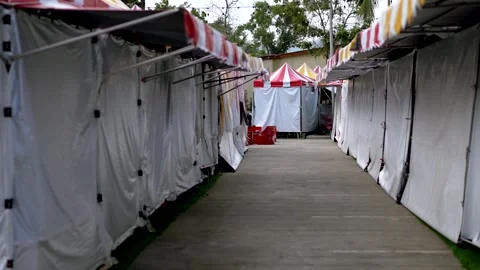 Empty Vendor Stalls with Red and Yellow Awnings in Outdoor Market Stock Footage 264348306