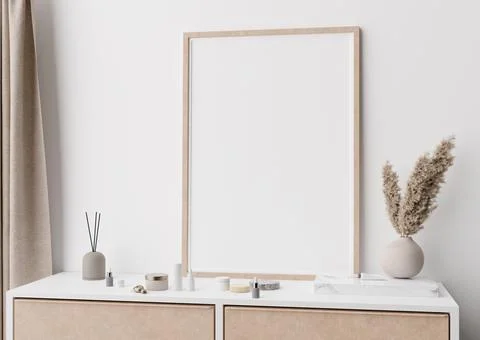 Empty vertical picture frame standing on console in modern bedroom. Mock up i Stock Photos