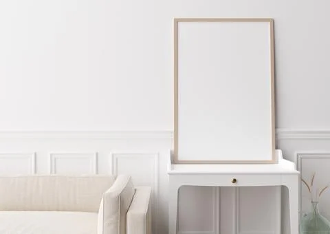 Empty vertical picture frame standing on console in modern living room. Mock  Stock Photos