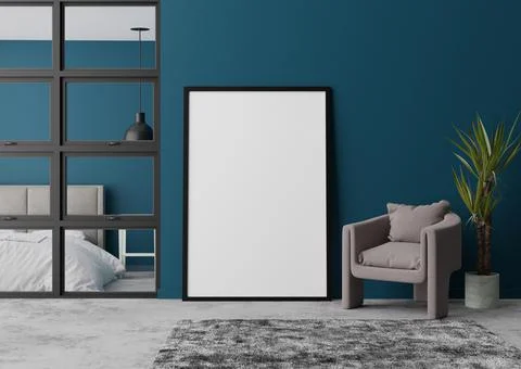 Empty vertical picture frame standing on concrete floor in modern bedroom. Mo Stock Photos