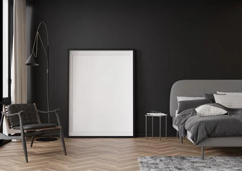 Empty vertical picture frame standing on parquet floor in modern bedroom. Moc Stock Photos