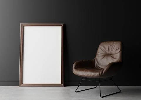 Empty vertical picture frame standing on the floor, with black wall and brown Stock Photos