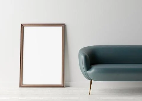 Empty vertical picture frame standing on the floor, with white wall and blue  Stock Photos