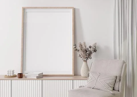 Empty vertical picture frame on white wall in modern living room. Mock up int Stock Photos