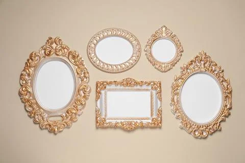 Empty vintage frames hanging on beige wall 写真素材