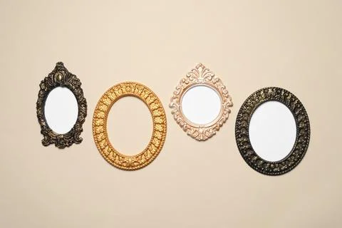 Empty vintage frames hanging on beige wall Stock Photos