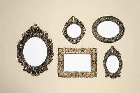 Empty vintage frames hanging on beige wall Stock Photos