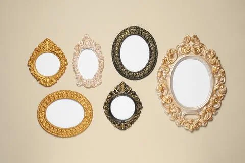 Empty vintage frames hanging on beige wall Stock Photos